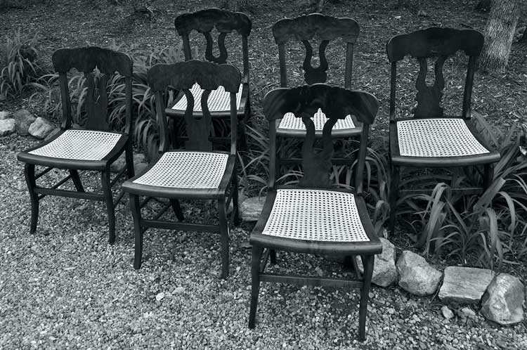 six hand caned antique chairs