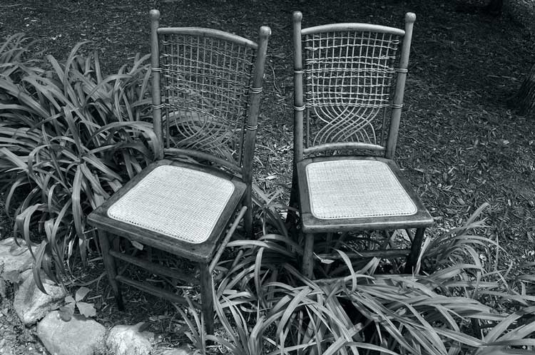 two pressed cane antique chairs